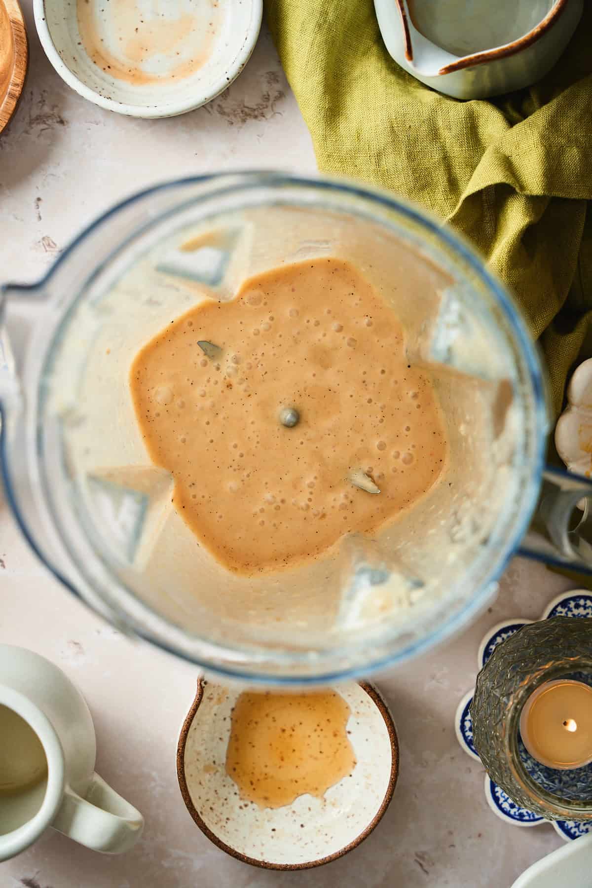 Blending apple cider dressing in a blender, all creamy and emulsified.