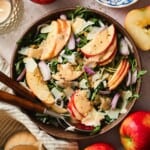 Arugula apple salad with sliced apples and vinaigrette.