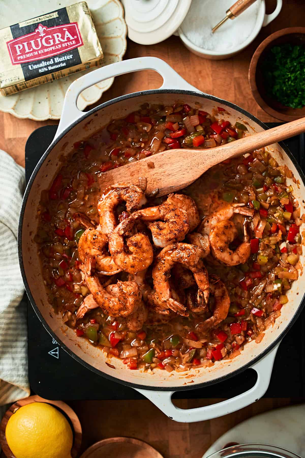 Shrimp added to the skillet with stock and cooked vegetables.