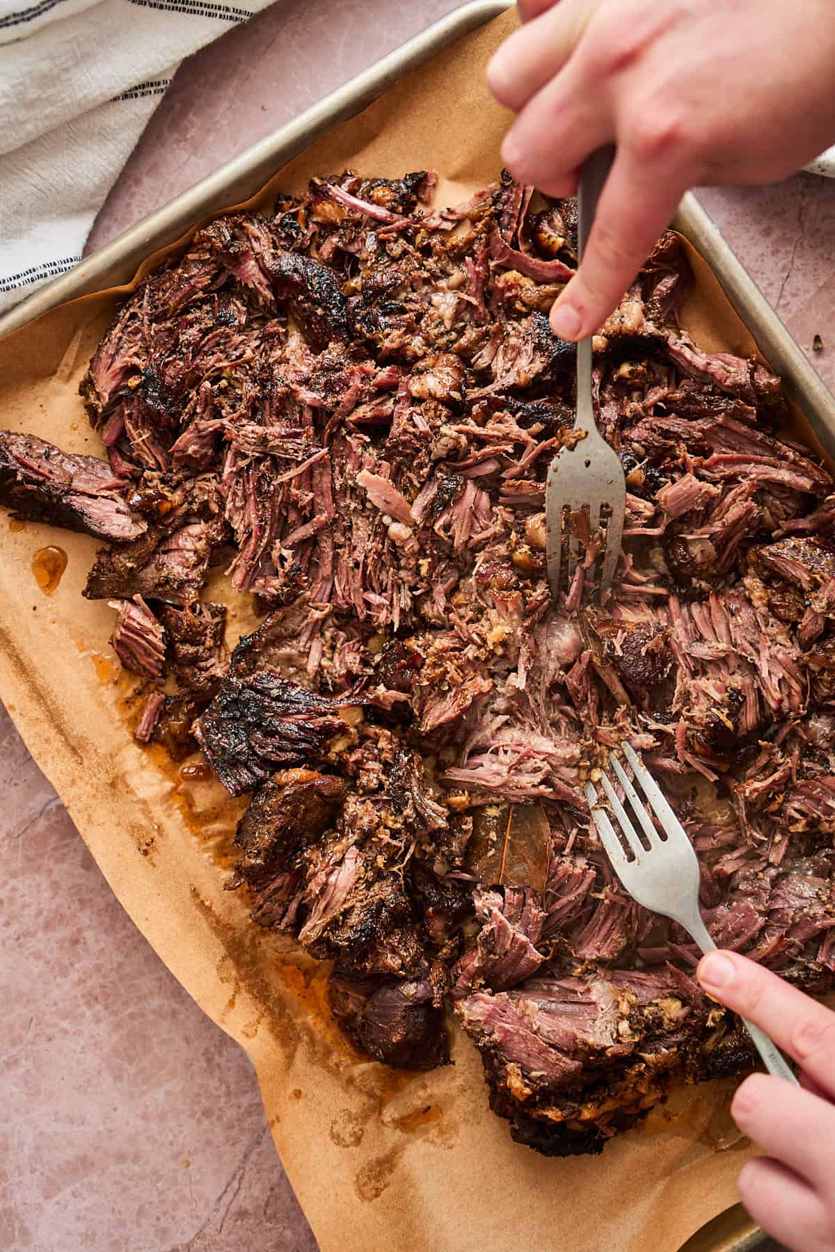 Shredding chuck roast with two forks.
