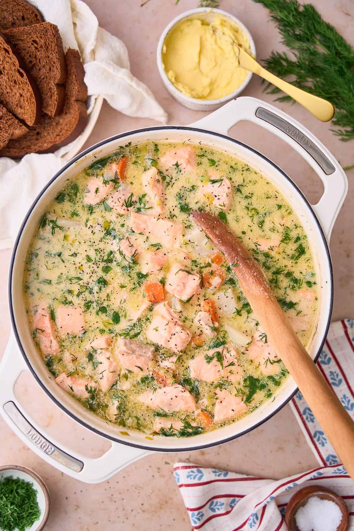 Salmon soup in a large Dutch oven with fresh dill in it.
