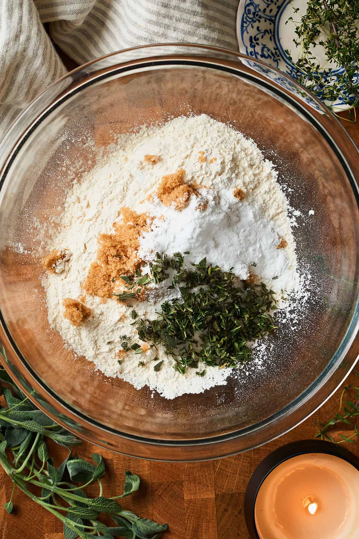 Dry ingredients to make herbed biscuits in a bowl with brown sugar and chopped herbs.