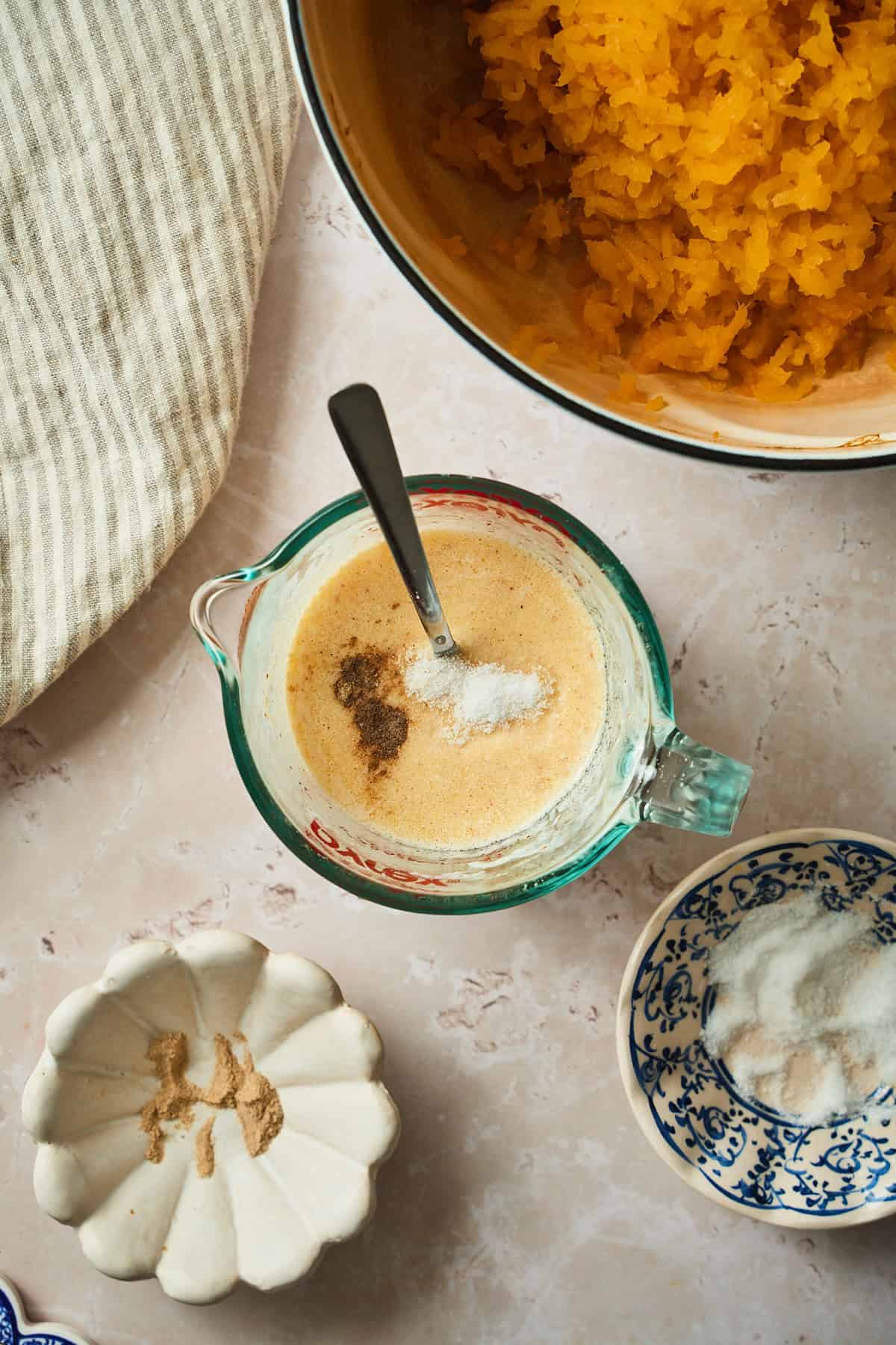 Warmed cream in a container with brown butter, salt, and pepper.