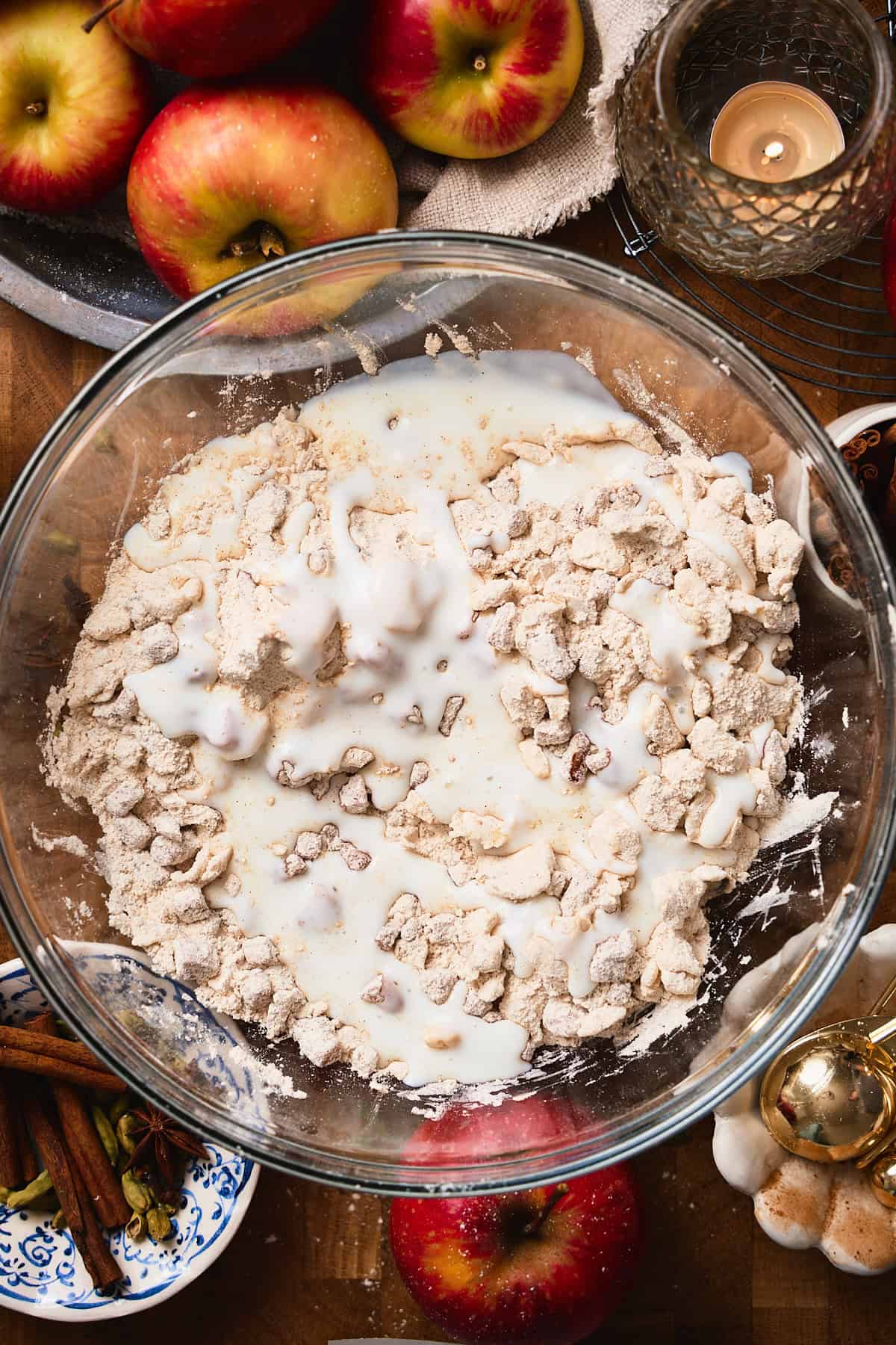 Buttermilk added to a bowl with flour, apples, and butter.