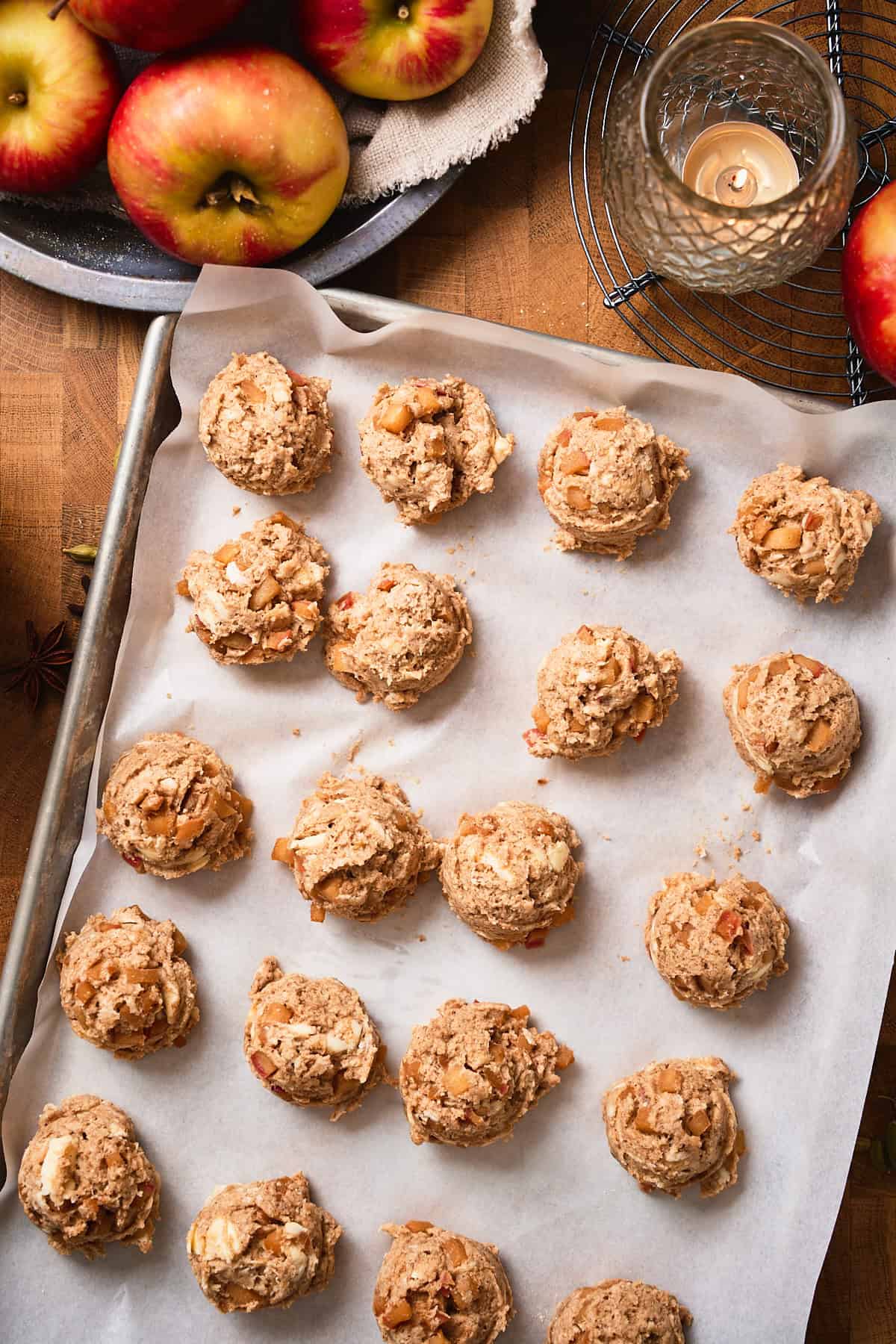 Apple biscuits on a baking sheet lined with parchment paper.