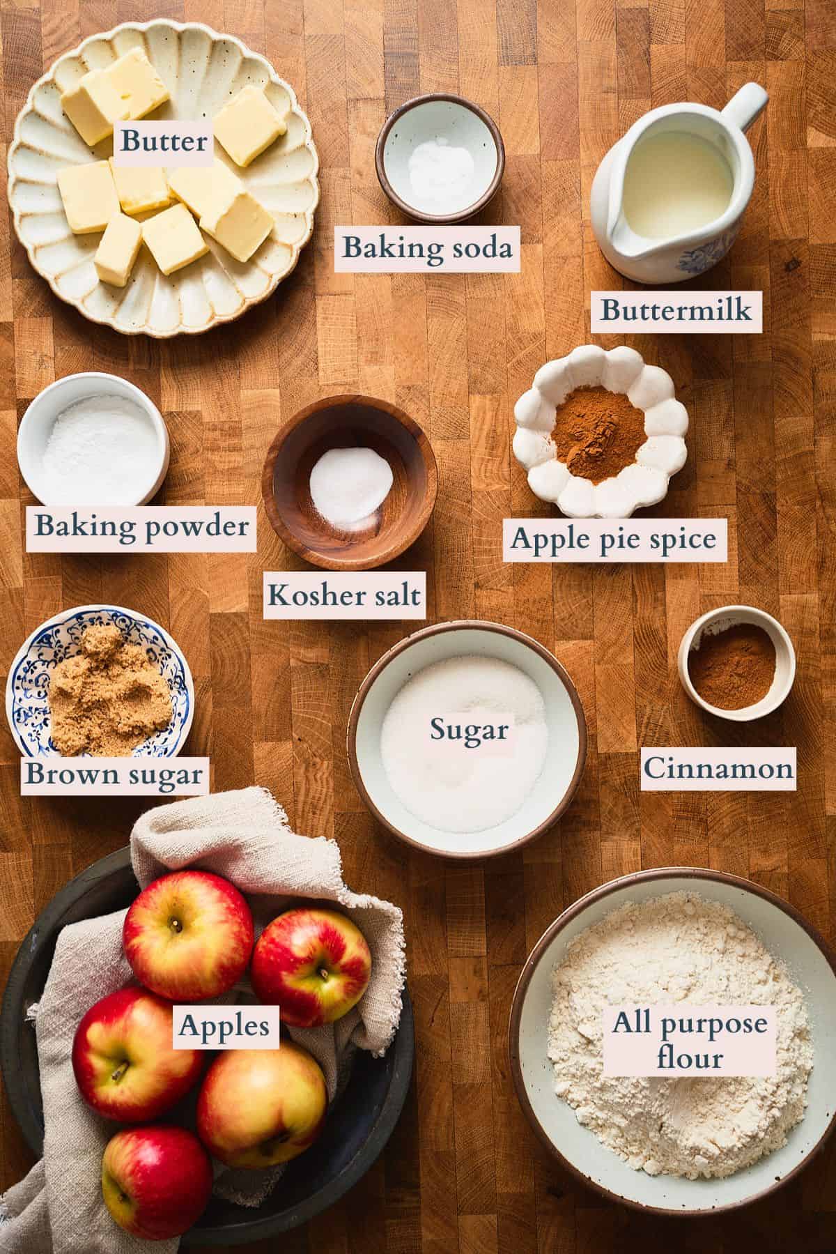Ingredients to make apple drop biscuits laid out of a table and labeled to denote each ingredient.