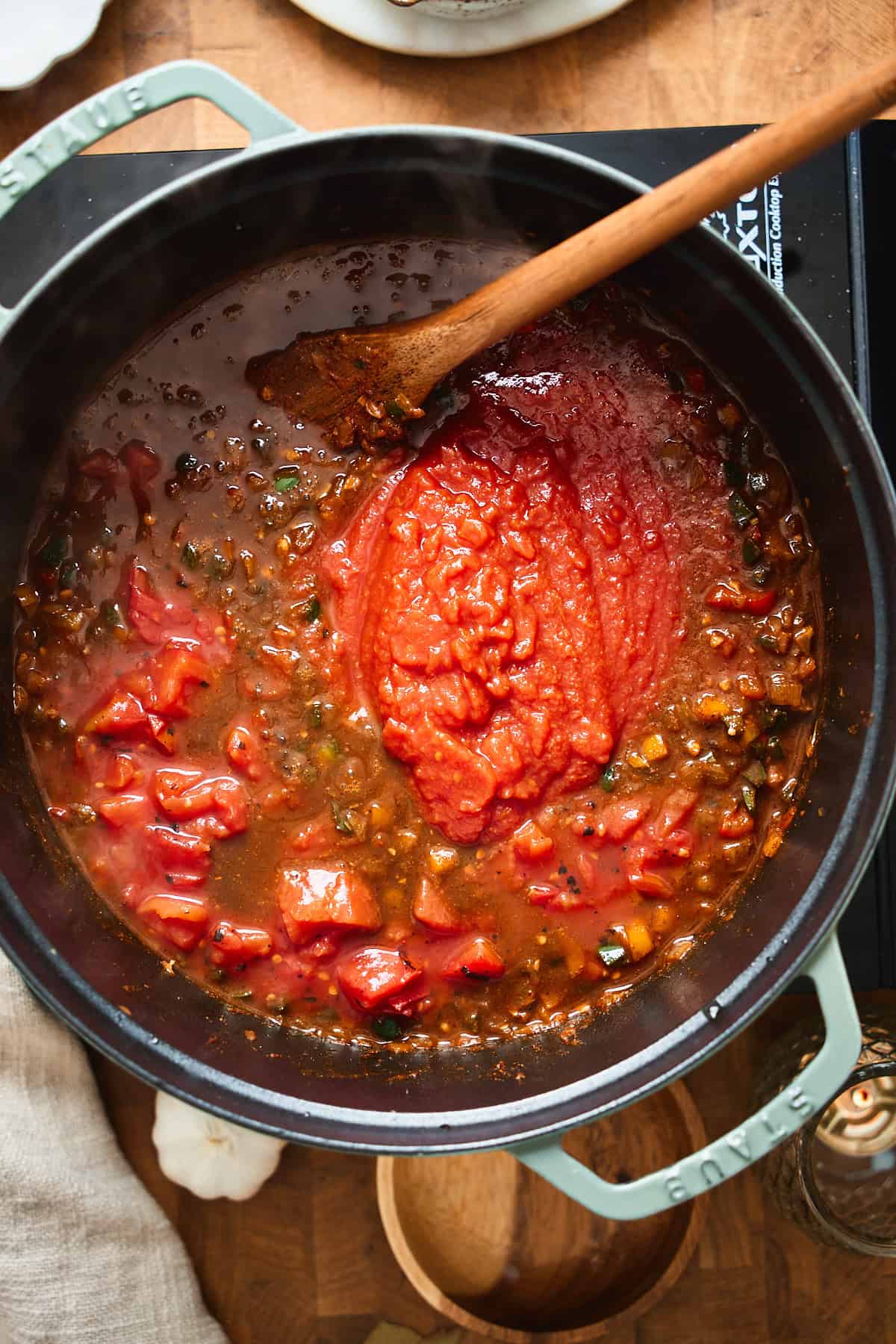 Crushed tomatoes and fire-roasted tomatoes added to the chili pot.