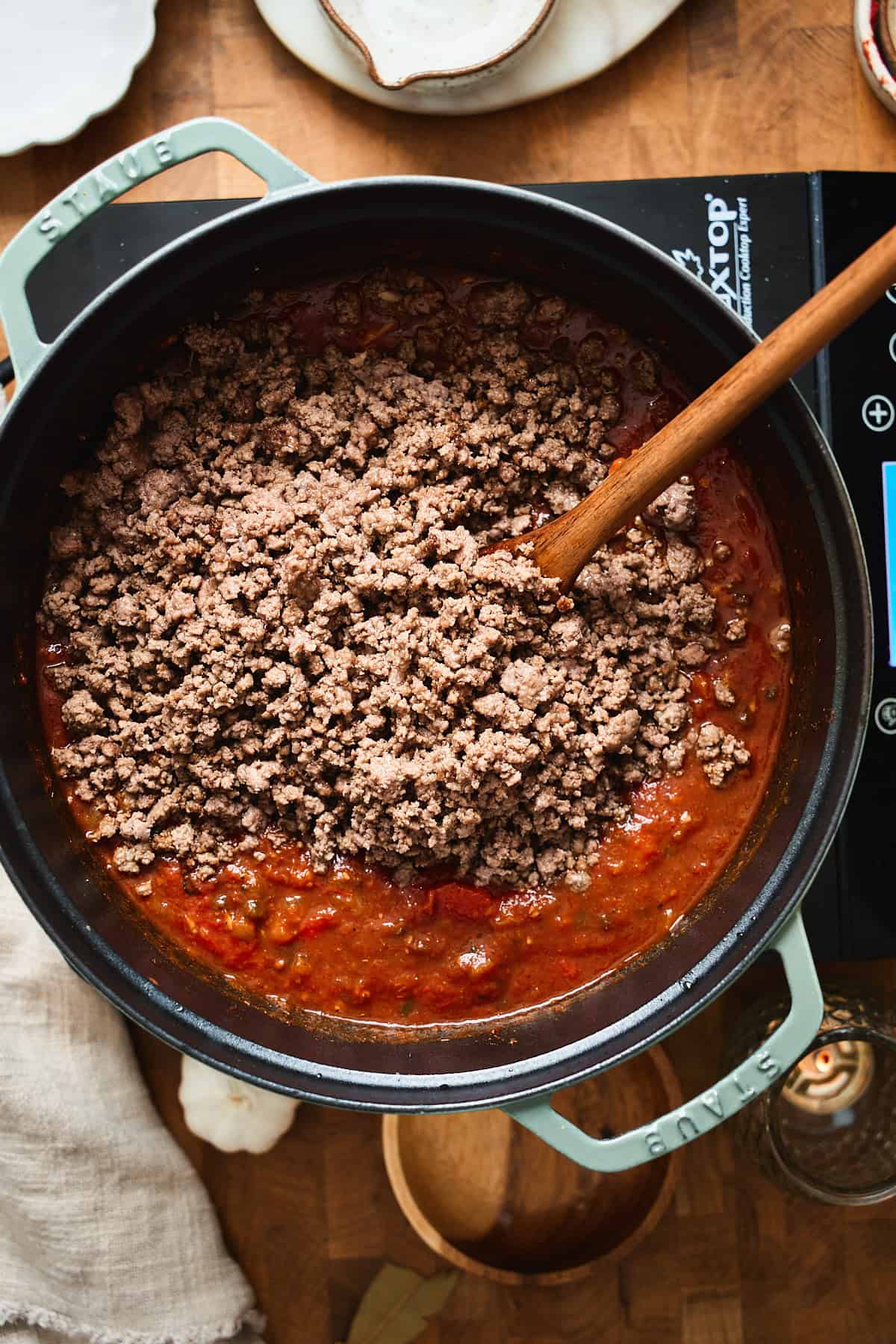 Browned ground beef added back into the tomato chili base.