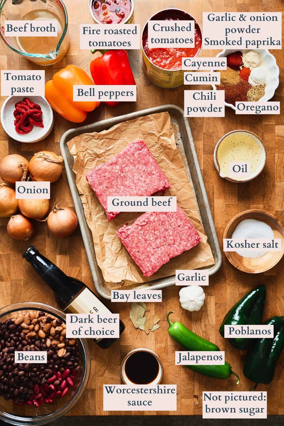 Ingredients for dark beer chili laid out on a wooden board and labeled.