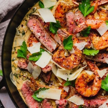 Creamy parmesan steak and shrimp skillet with garlic cream sauce.