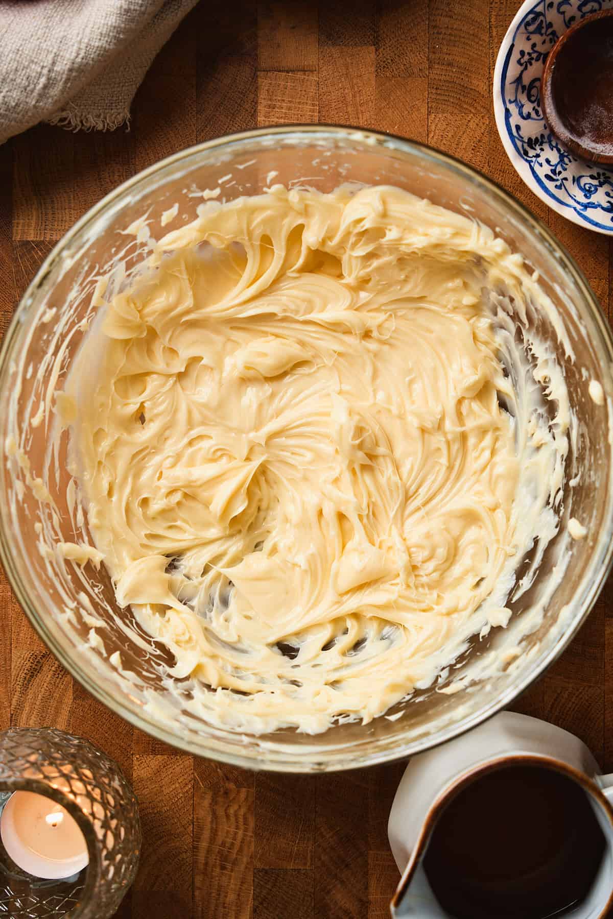 Softened butter whipped smooth and creamy in a glass bowl.