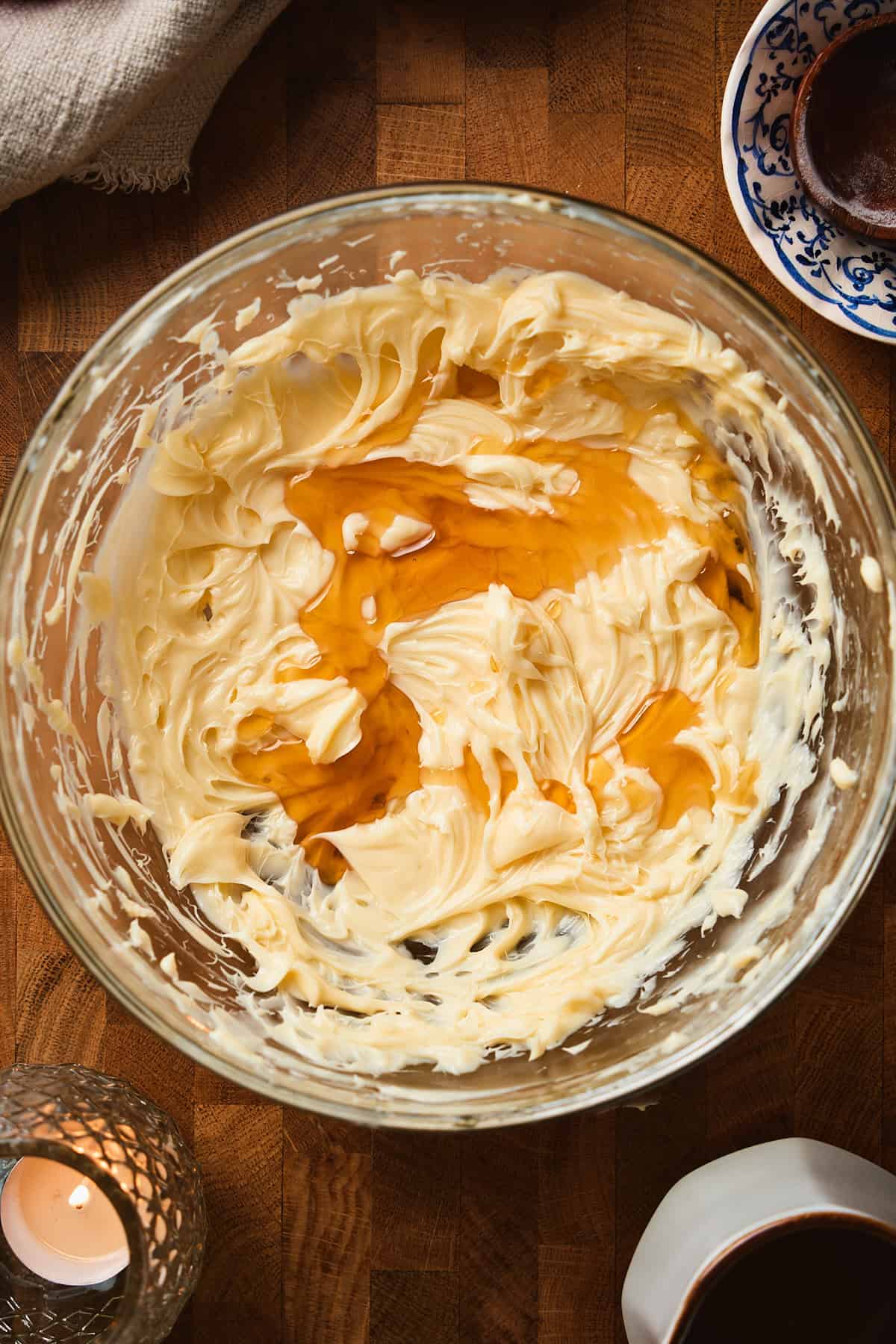 Softened butter whipped smooth and creamy topped with more maple syrup in a glass bowl.