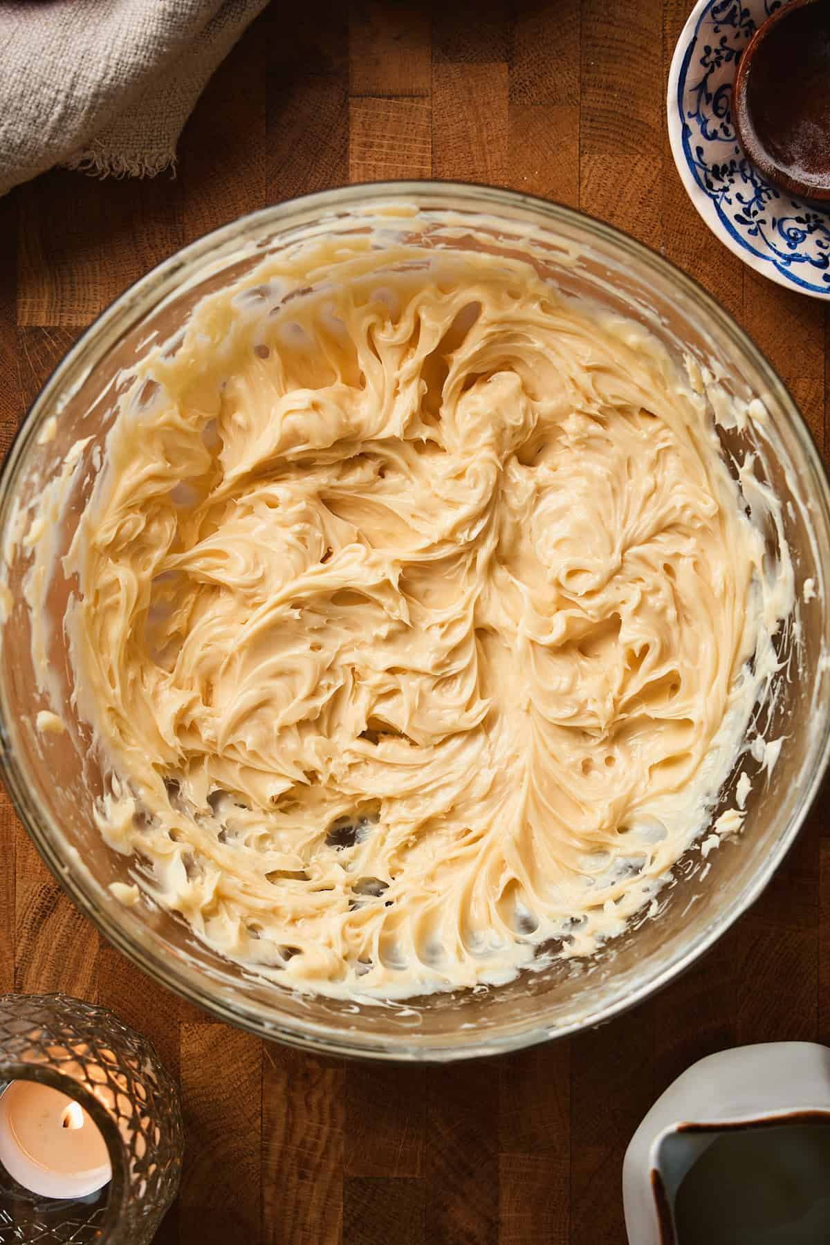 Whipped maple butter with fluffy swirls in a glass mixing bowl.