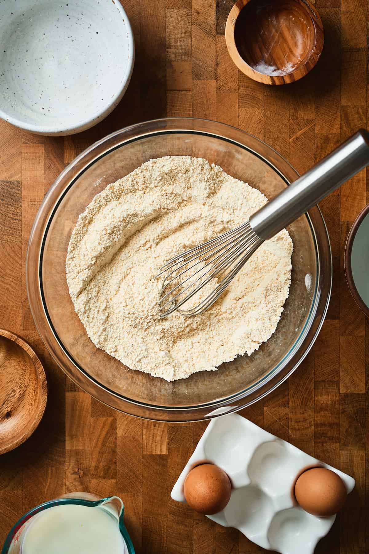 Whisked dry ingredients to make cornbread in a bowl.