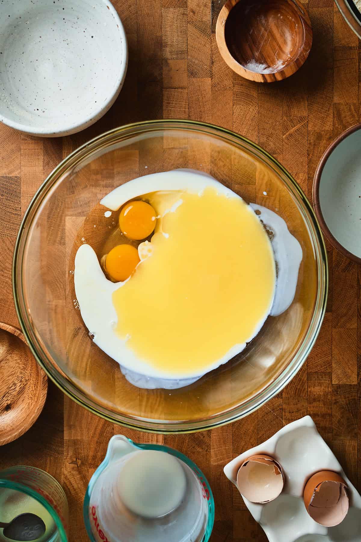 Melted butter, eggs, and buttermilk in a bowl.