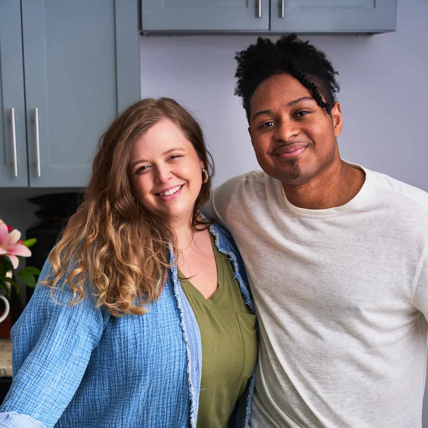 husband and wife of A Full Living hugging and posing in the kitchen.