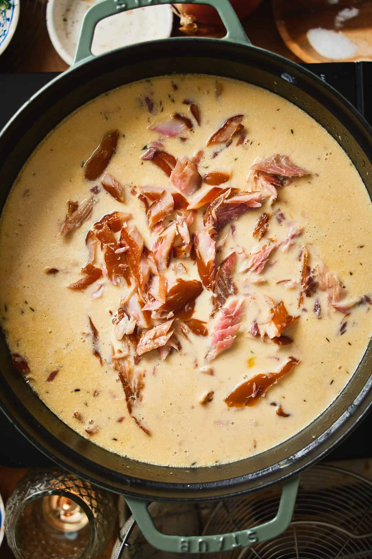Flaked smoked whitefish added to the creamy chowder in a Dutch oven.