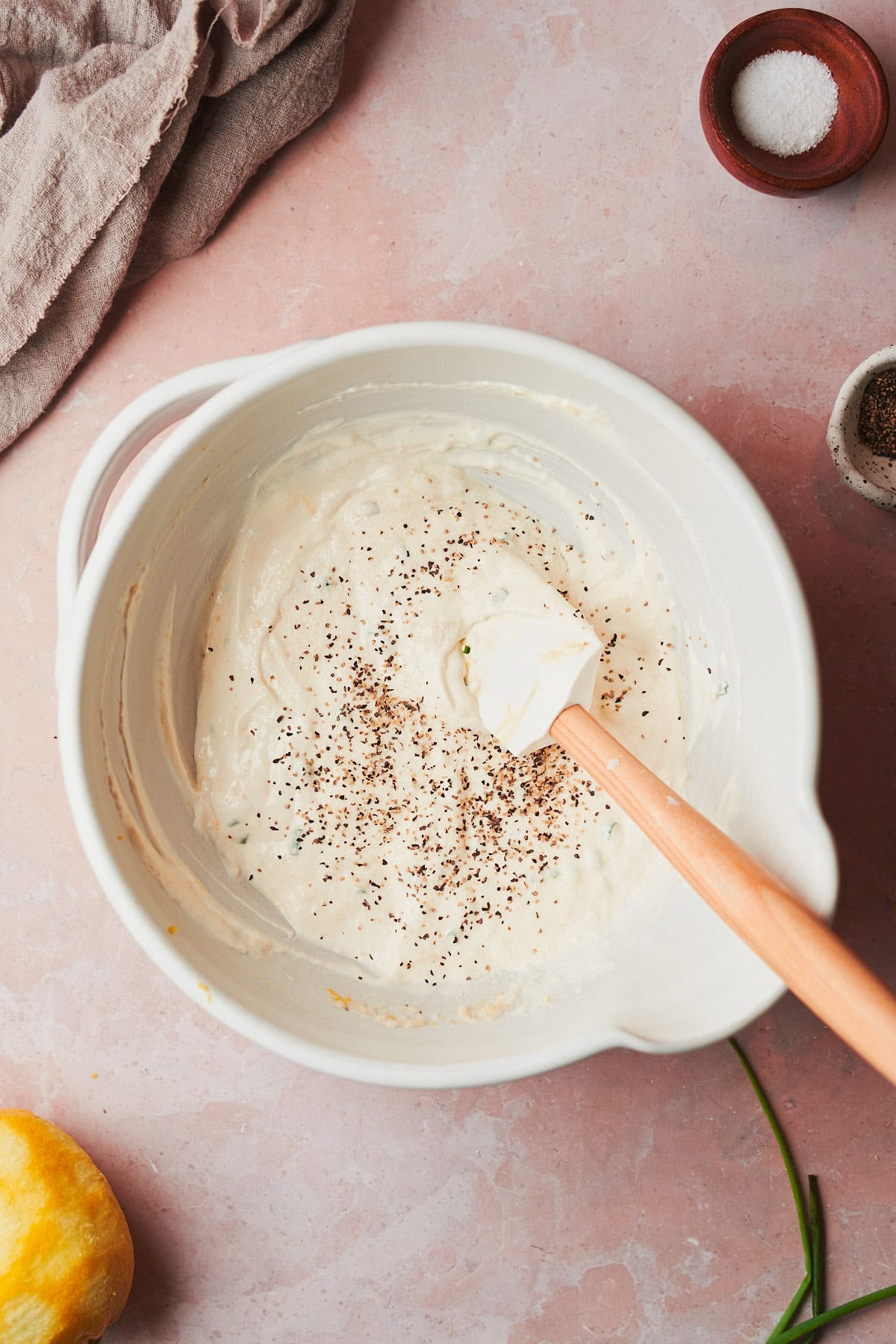 creamy horseradish sauce mixed together with salt and pepper added to the bowl with a rubber spatula.