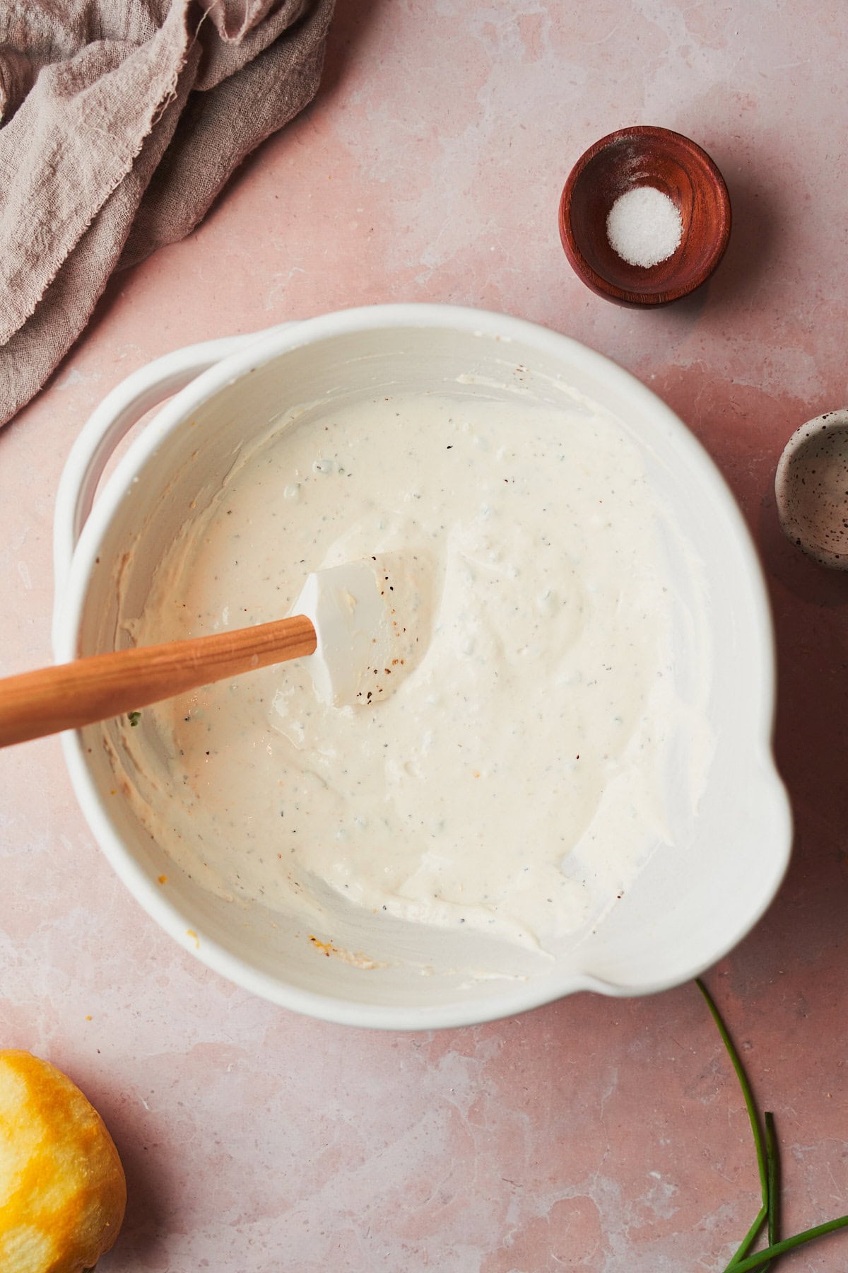 creamy horseradish sauce stirred together in a bowl with a rubber spatula.
