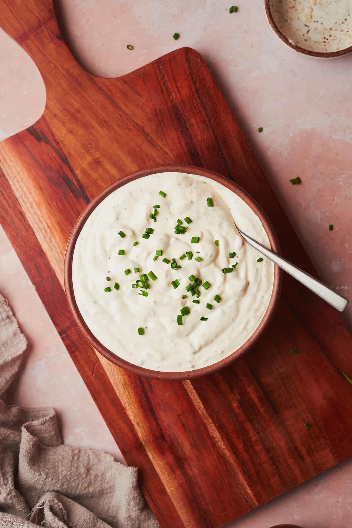 horseradish dipping sauce in a bowl topped with chives.