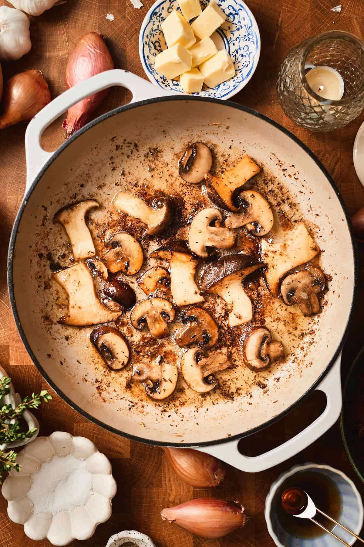 Golden brown mushrooms searing in a pan.