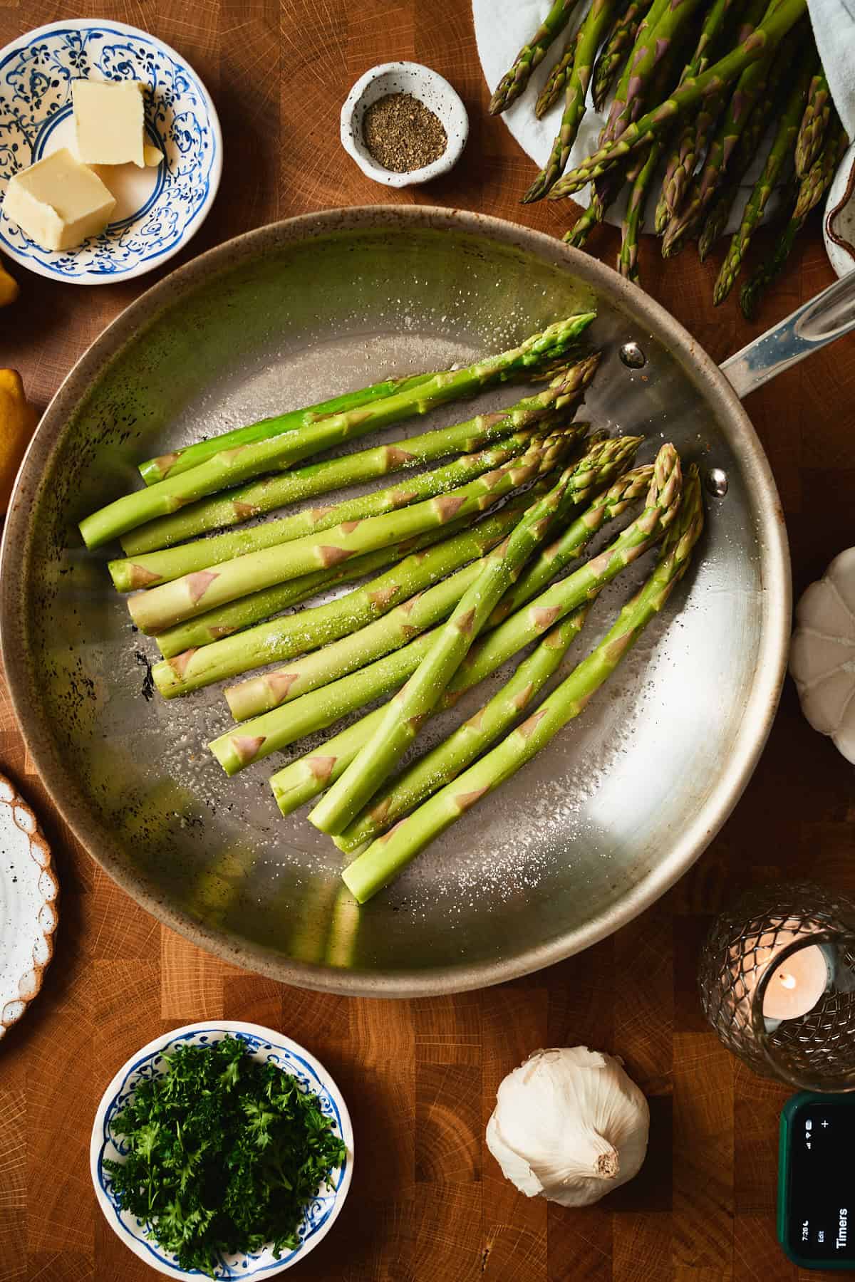 Fresh asparagus spears in a single layer in a hot skillet, ready to sauté.