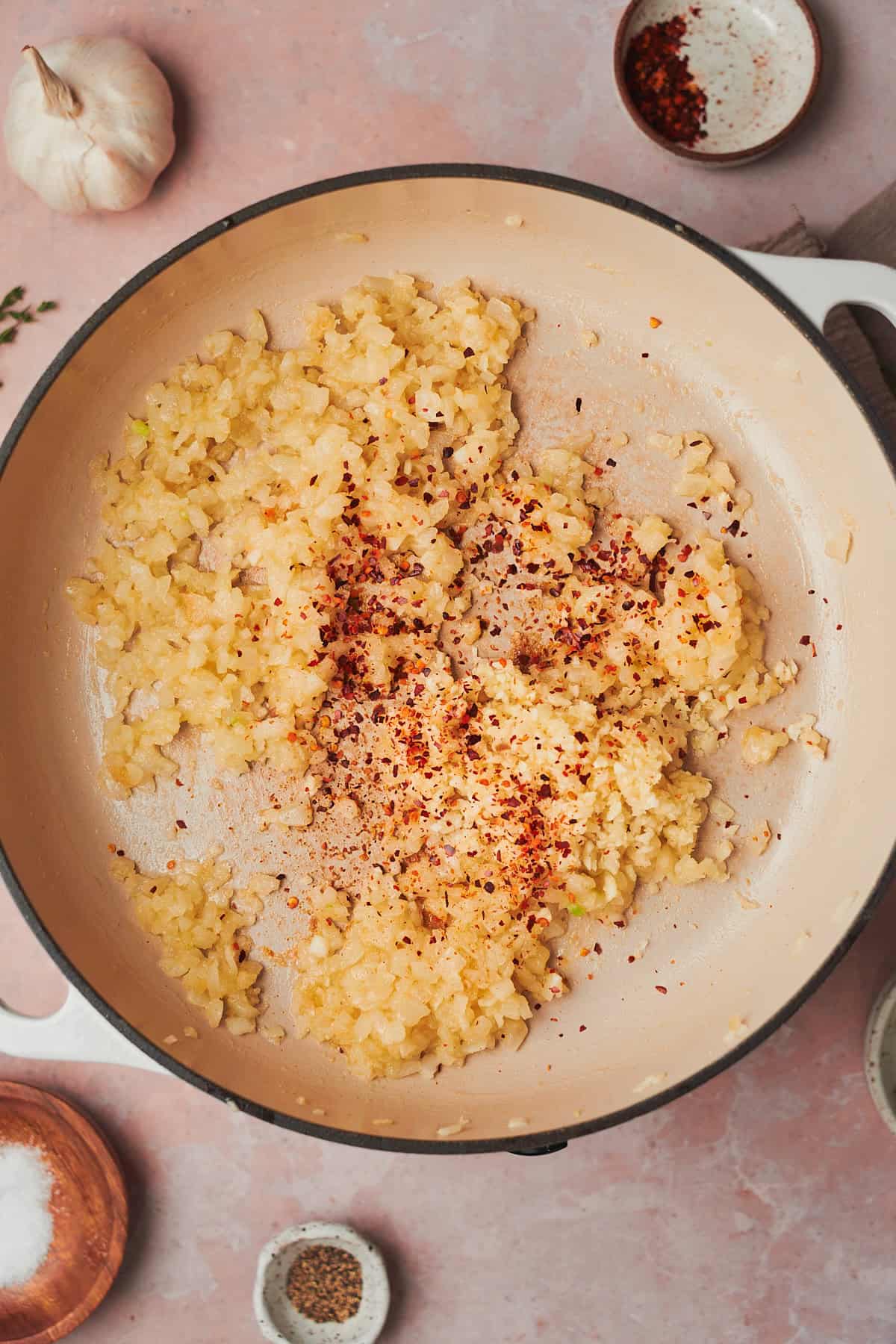 cooked onions in a skillet with garlic and red pepper flakes.