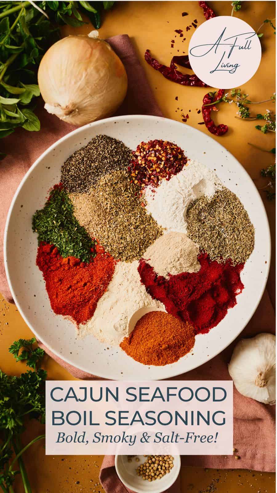 Overhead view of Cajun seafood boil seasoning ingredients arranged in a speckled bowl with text overlay reading Cajun Seafood Boil Seasoning, Bold, Smoky and Salt-Free.
