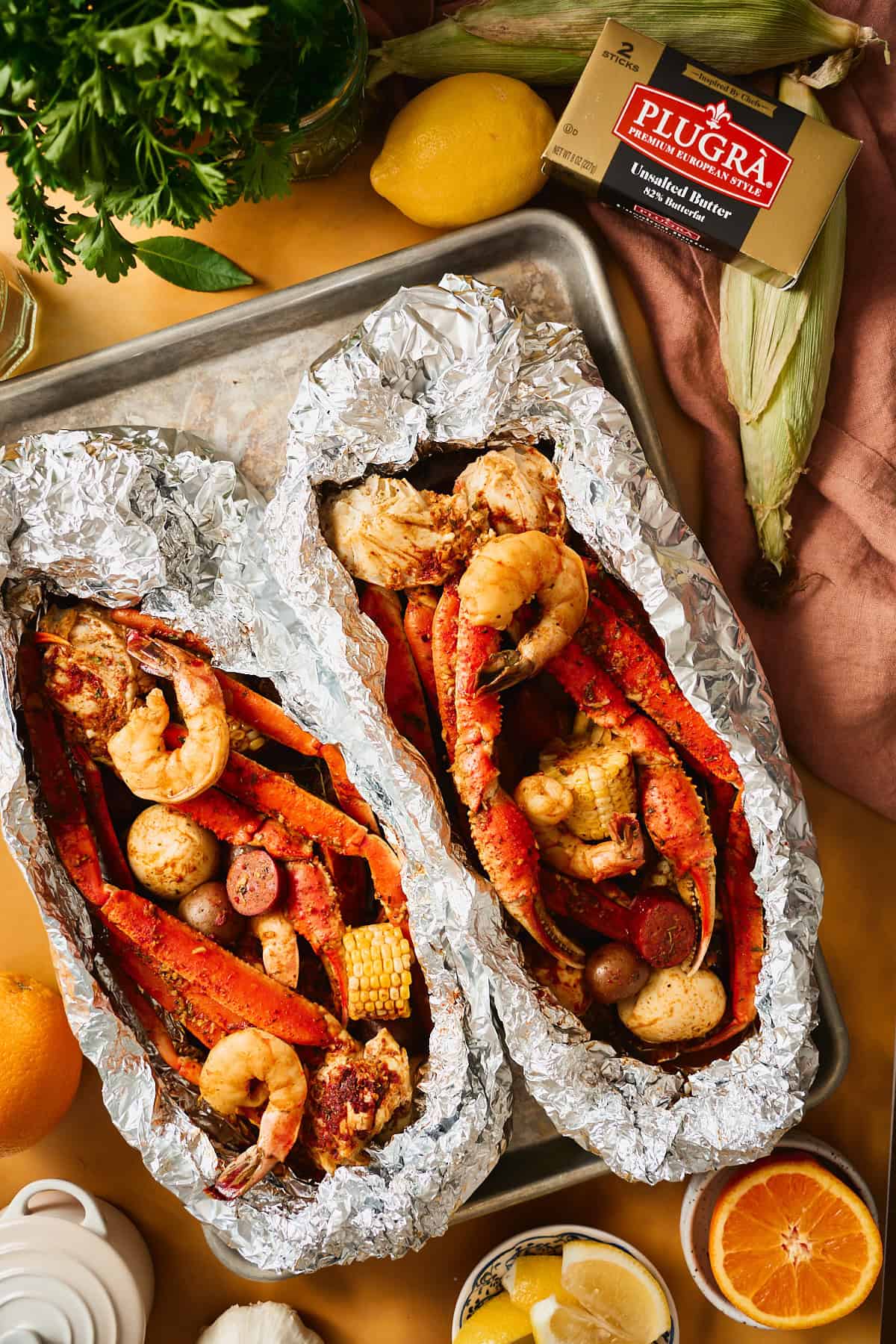Open foil packets with cooked shrimp and crab out of the oven right after baking.