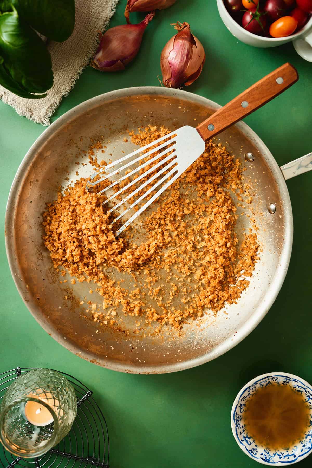 Golden toasted beef bacon fat breadcrumbs in a skillet for topping tomato bacon pasta.