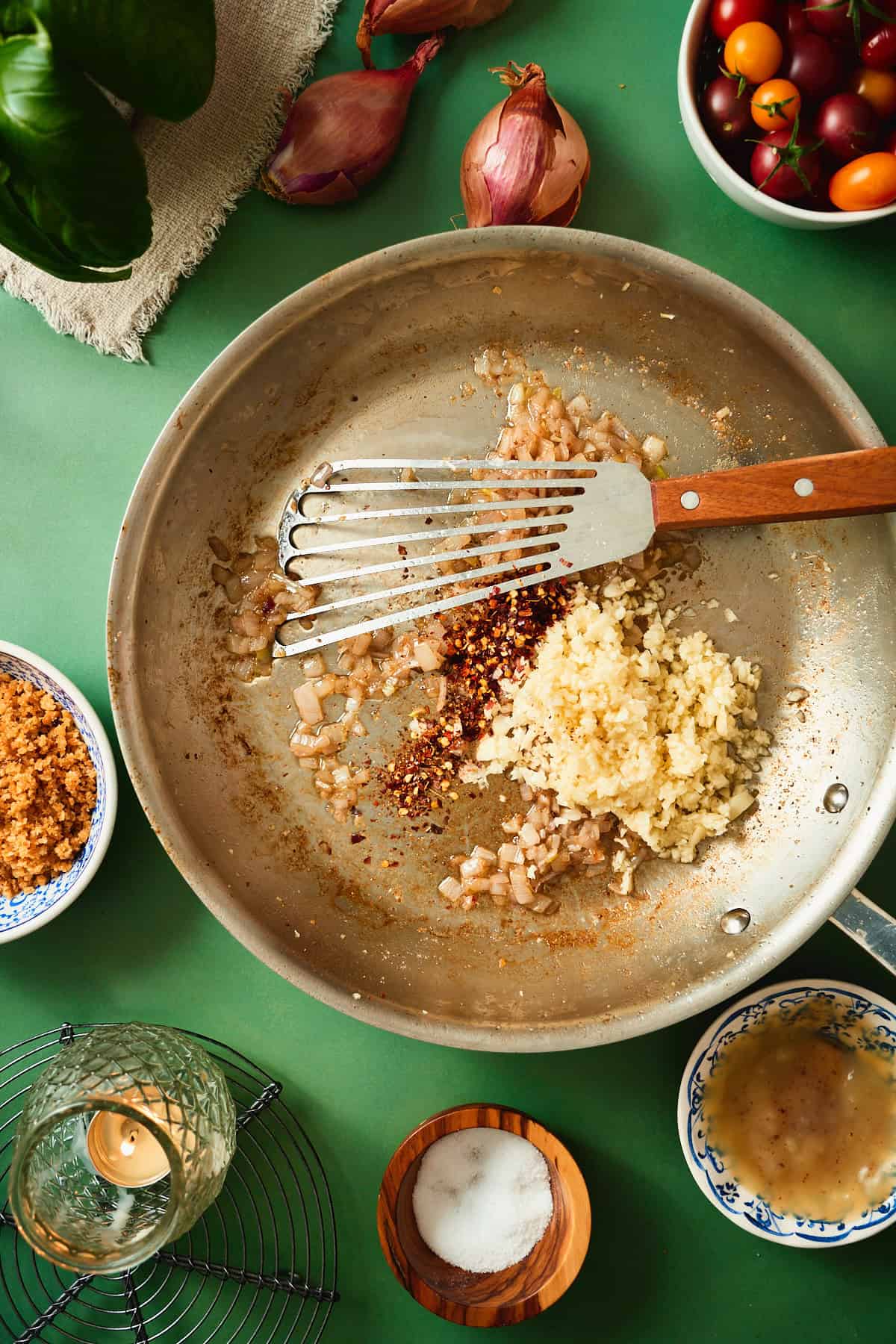 Shallots, garlic, and red pepper flakes cooking in beef bacon fat for blistered tomato pasta sauce.