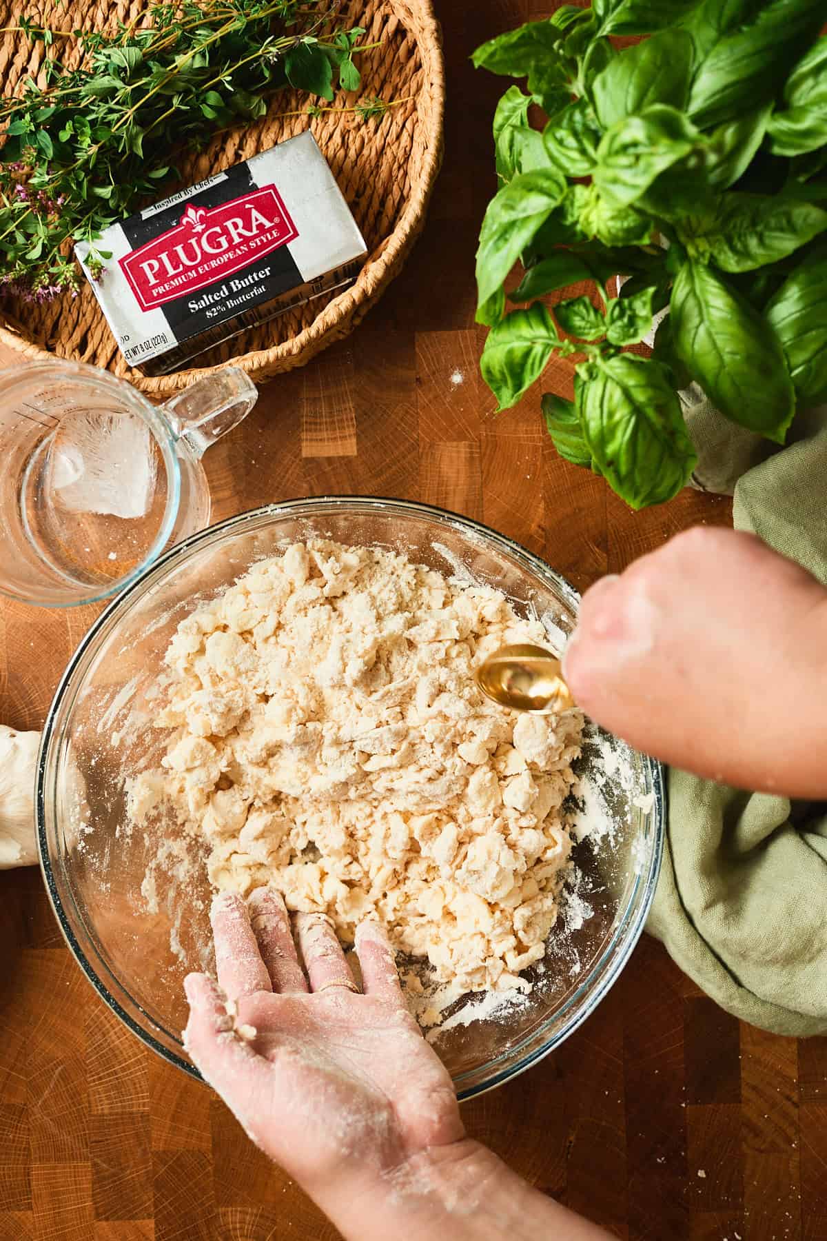 Ice water added a tablespoon at a time to flour and butter for tomato galette dough.