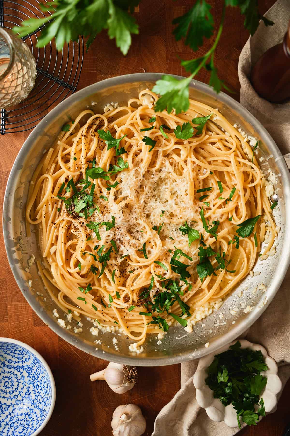 Grated Parmesan, chopped parsley, and black pepper piled onto the pasta off the heat.