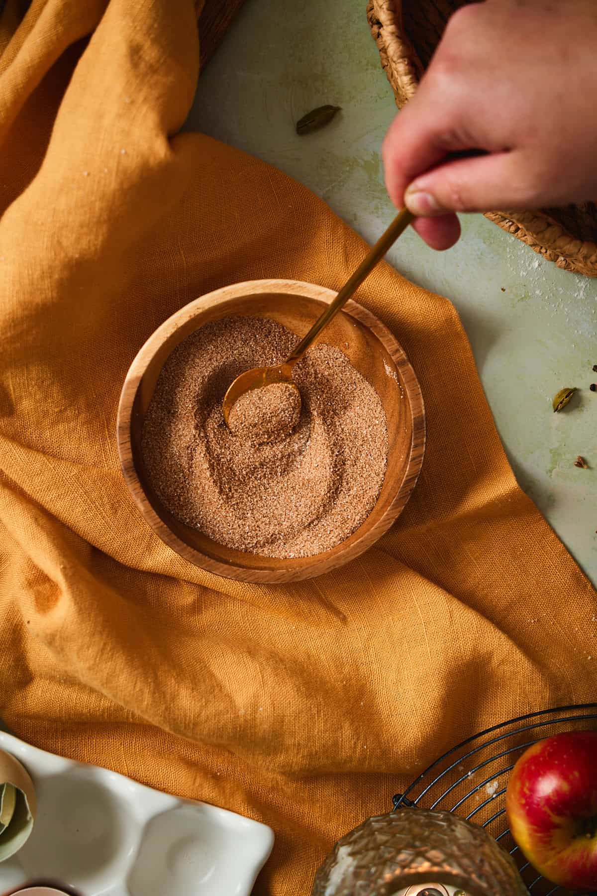 Cinnamon and sugar stirred together in a small wooden bowl.