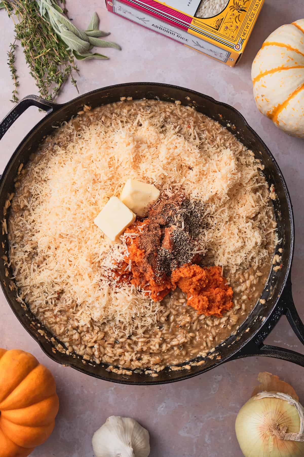 Pumpkin purée, grated parmesan, butter, nutmeg, and black pepper added to finished risotto in a cast iron skillet.