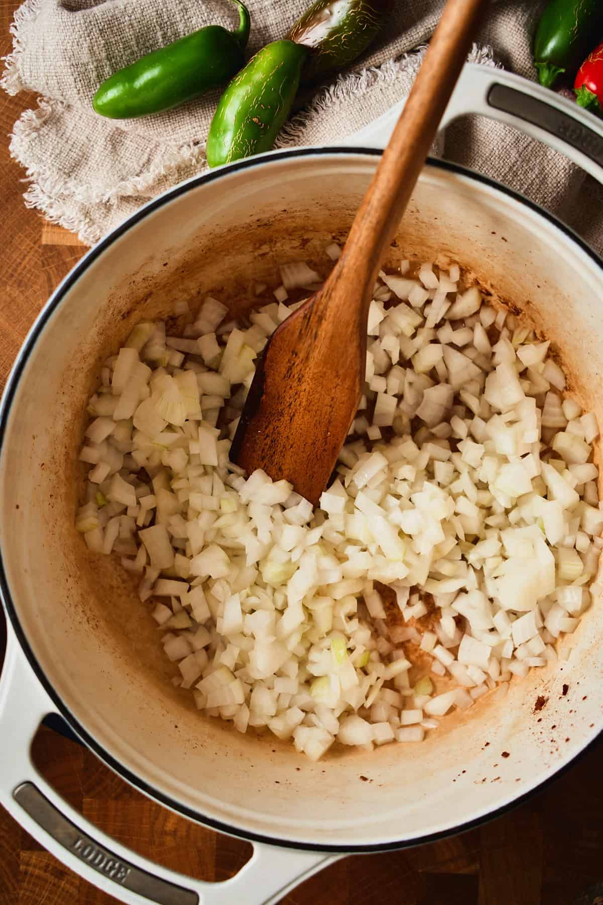 Diced onion added to rendered beef bacon fat and browned bits in a Dutch oven.