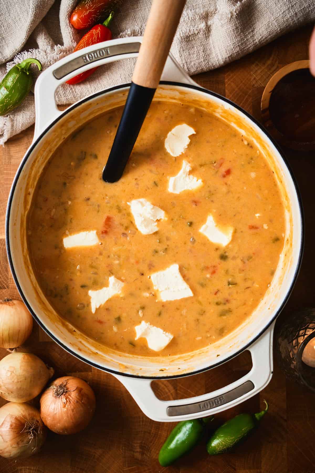 Cubes of cream cheese melting into creamy jalapeño popper soup.